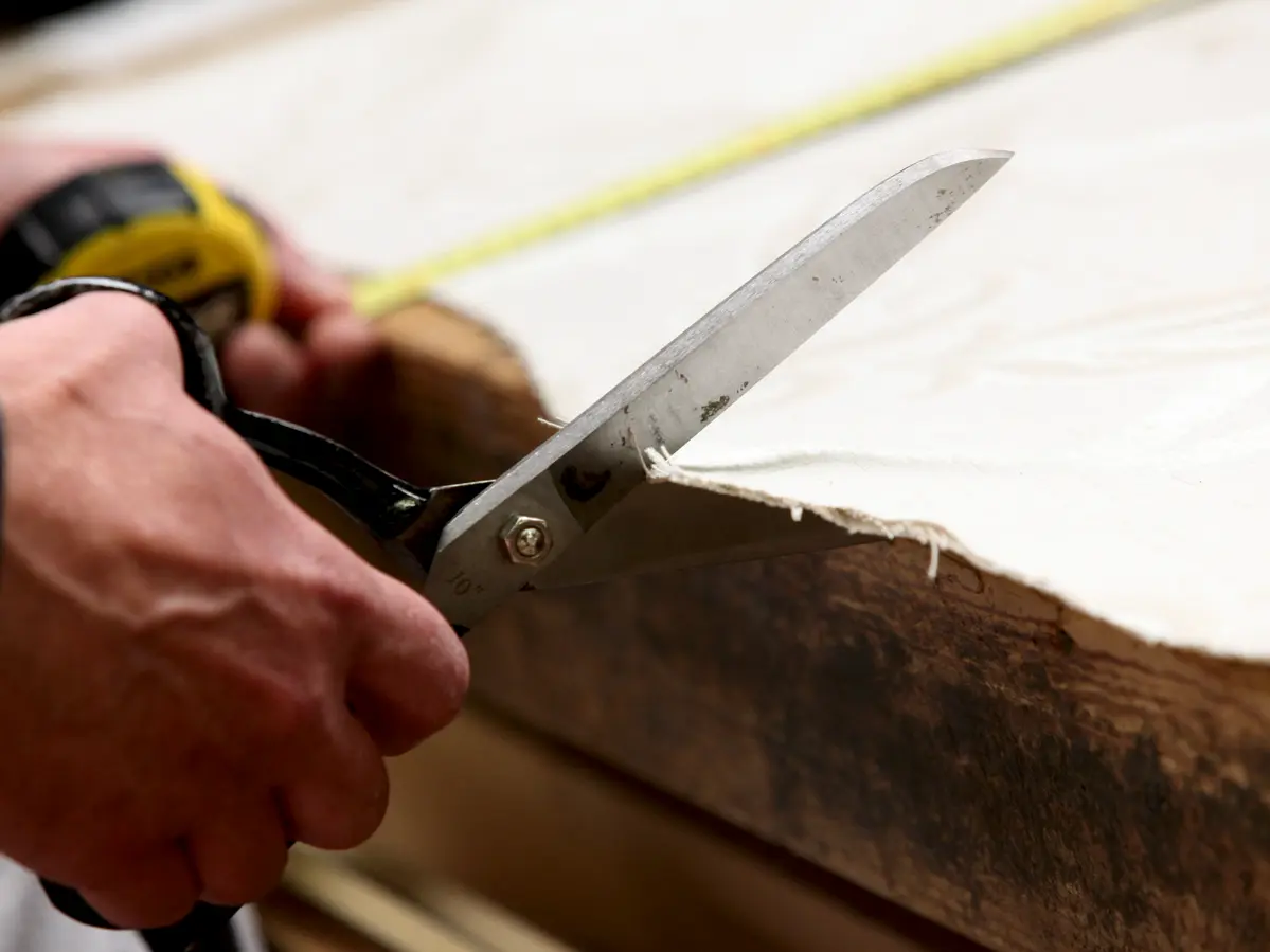 Cutting fabric with scissors at Ralvern Upholstery based in Cannock