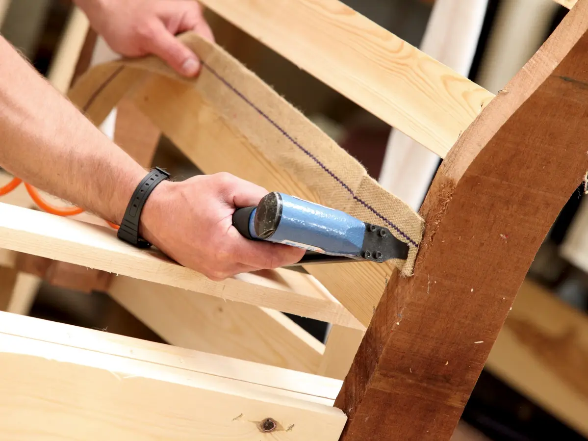 Woodworking with staple gun at Ralvern Upholstery based in Cannock