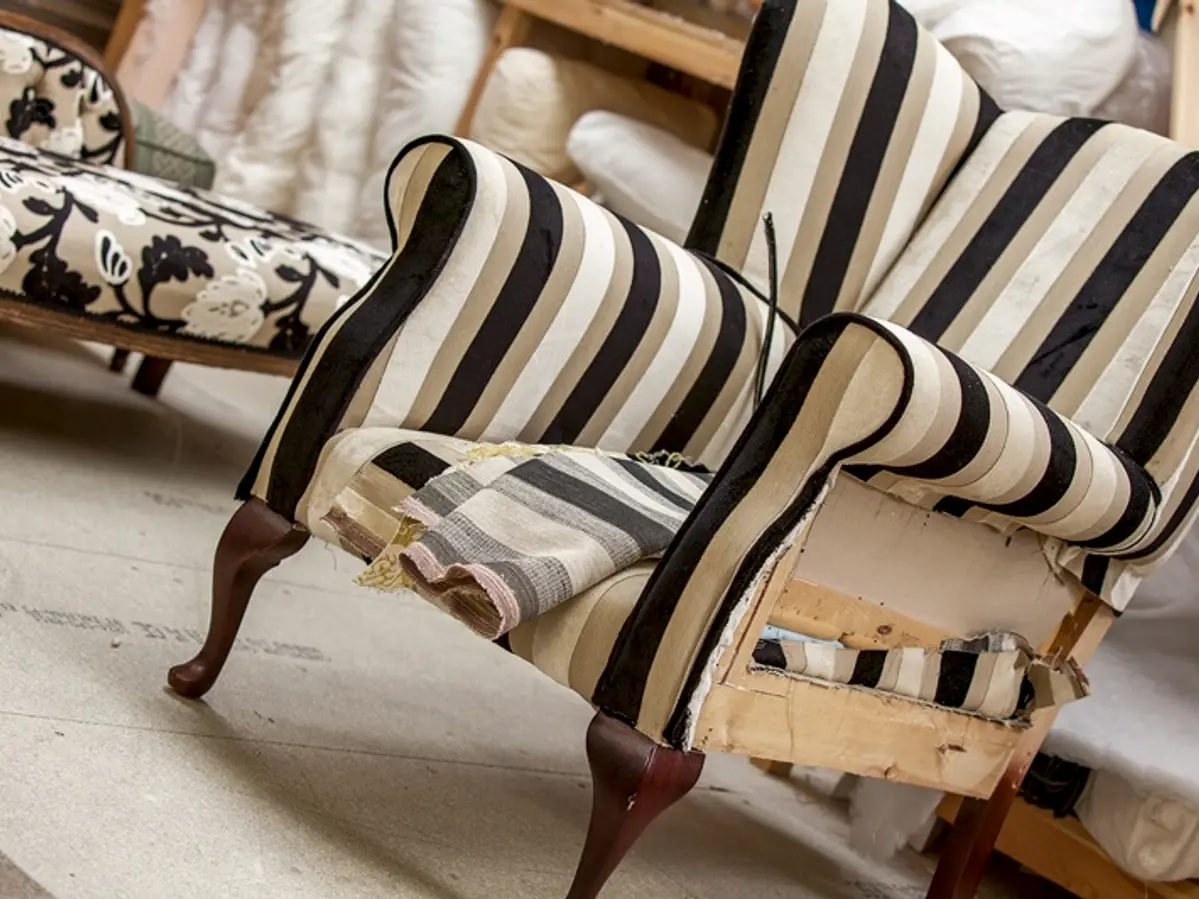 Wingback armchair being reupholstered in striped fabric at the Ralvern Upholstery workshop in Cannock
